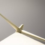 Upwards photo of a wind turbine tower and blades